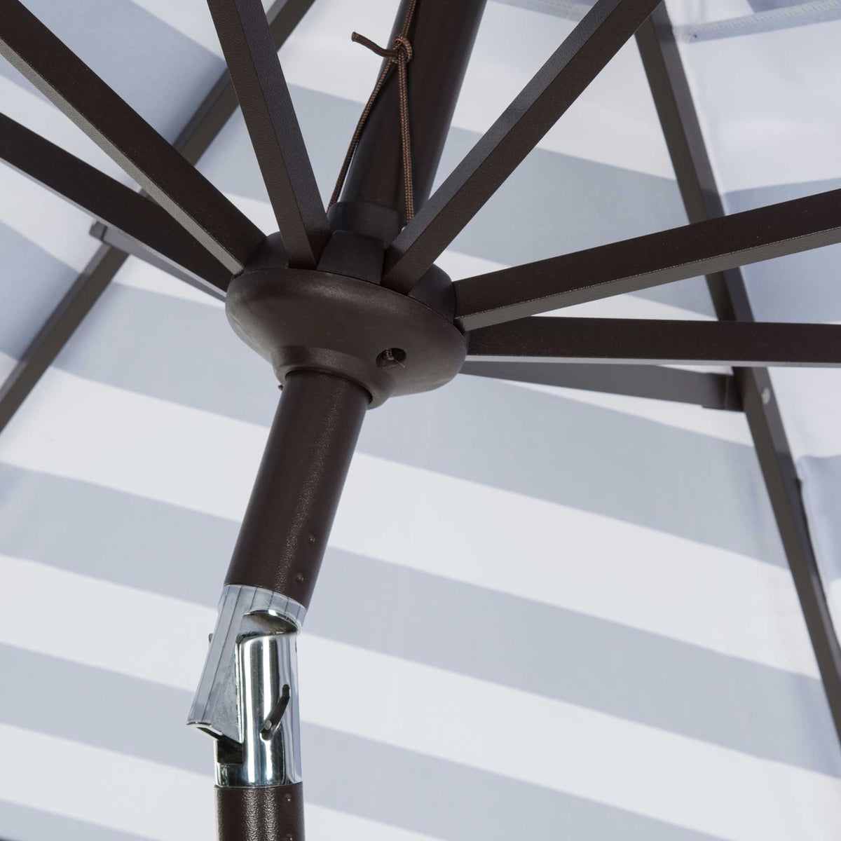 Dark ribs radiate from a central hub above the shiny silver tilt hinge.