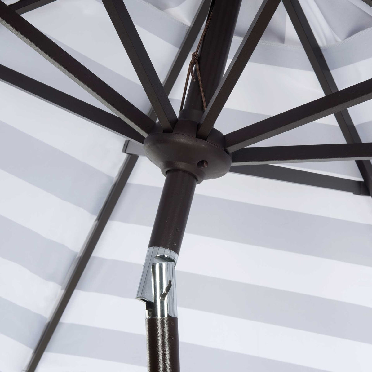 Dark support ribs meet at a sturdy hub above the silver tilt mechanism.