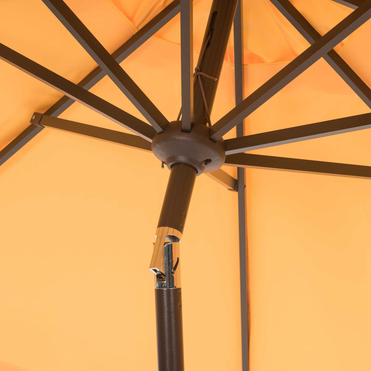 Metal ribs spread beneath the yellow fabric from a central hub above a hinged metal pole.