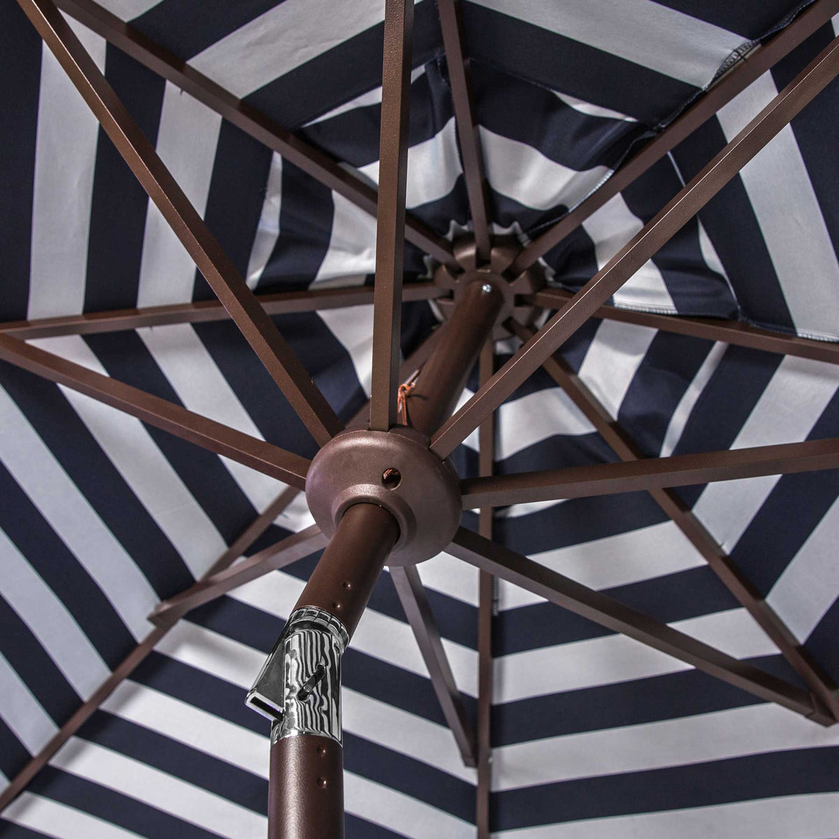 Navy-and-white stripes radiate around the center hub and sturdy umbrella ribs.
