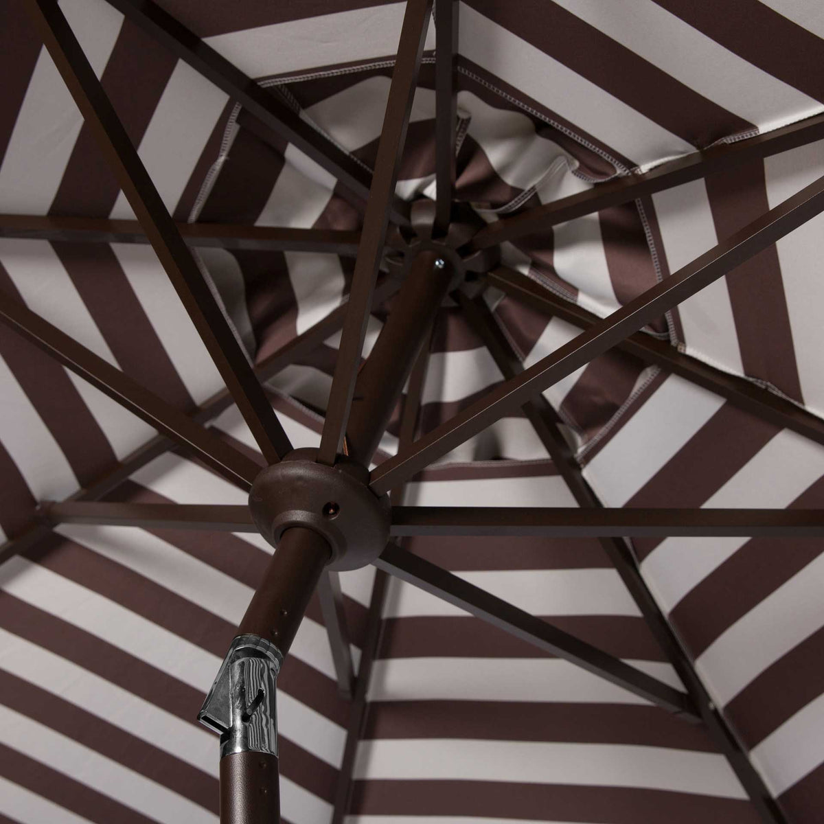 Brown-and-white striped fabric surrounds a sturdy metal hub and spreading canopy ribs.