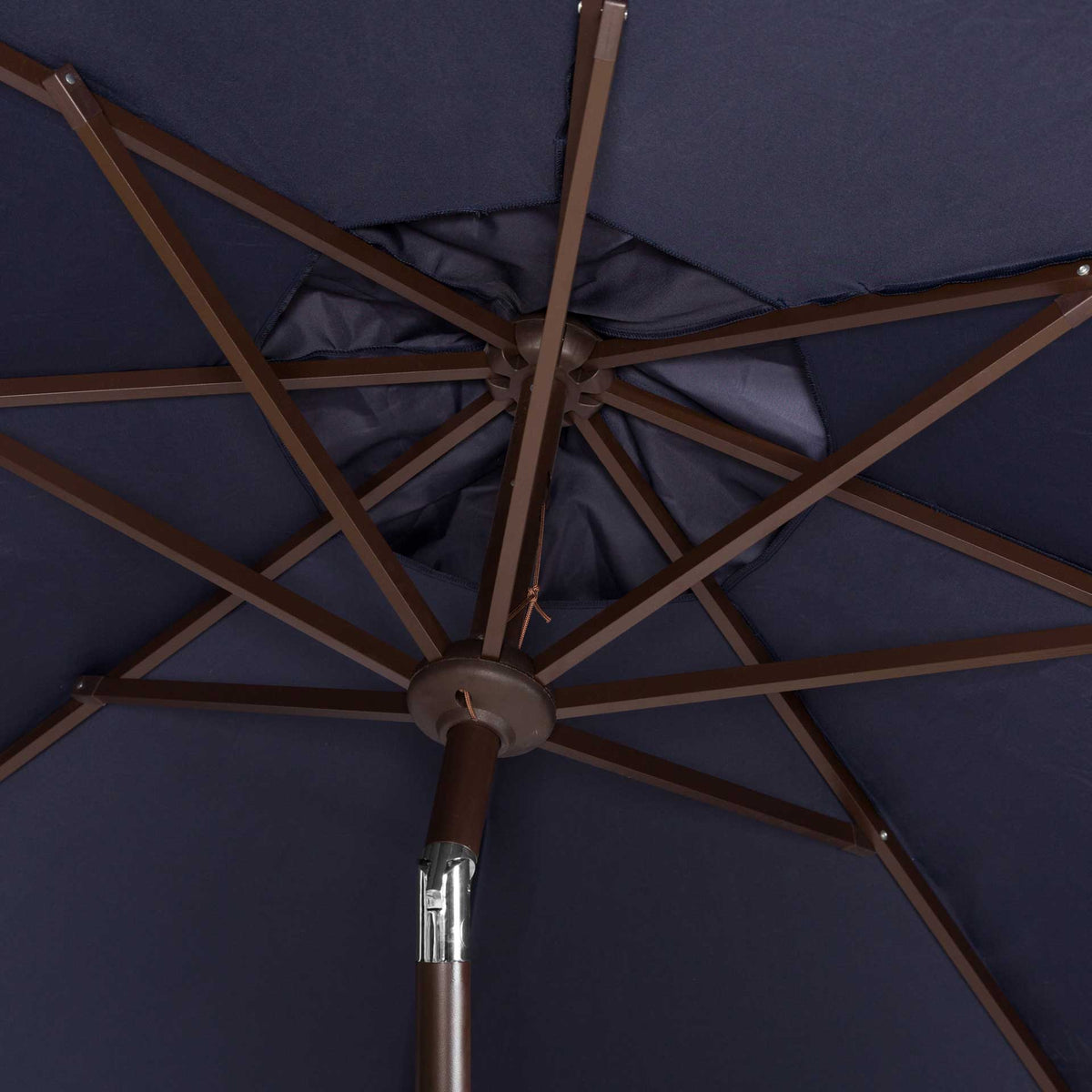 Brown metal ribs radiate from a central hub beneath the deep navy umbrella canopy.