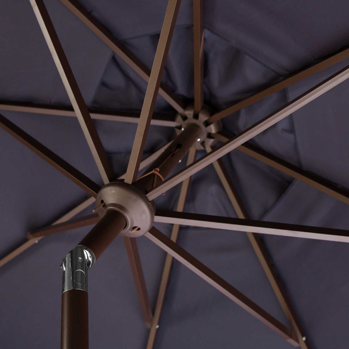Brown ribs radiate from the central hub beneath a deep navy polyester canopy