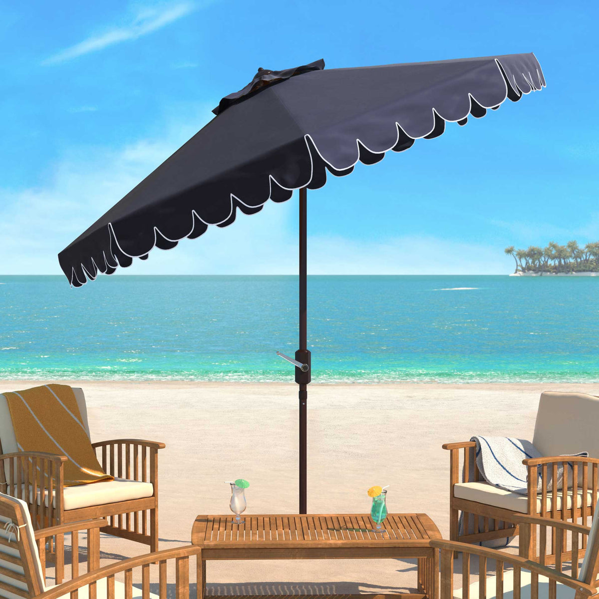 Navy umbrella brings a white-trimmed scalloped canopy to a seaside seating area