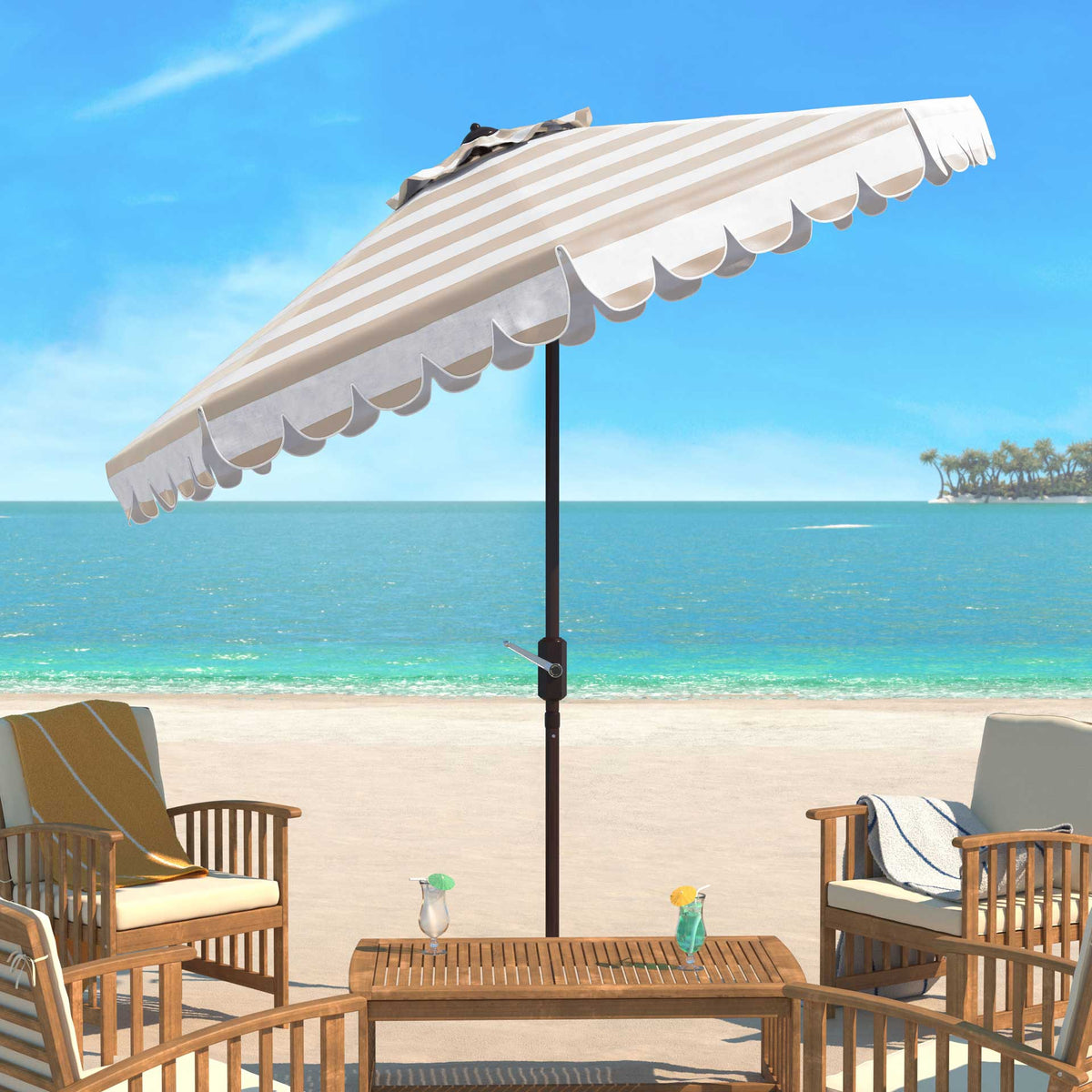 A beige and white scalloped umbrella shades a coastal patio seating area
