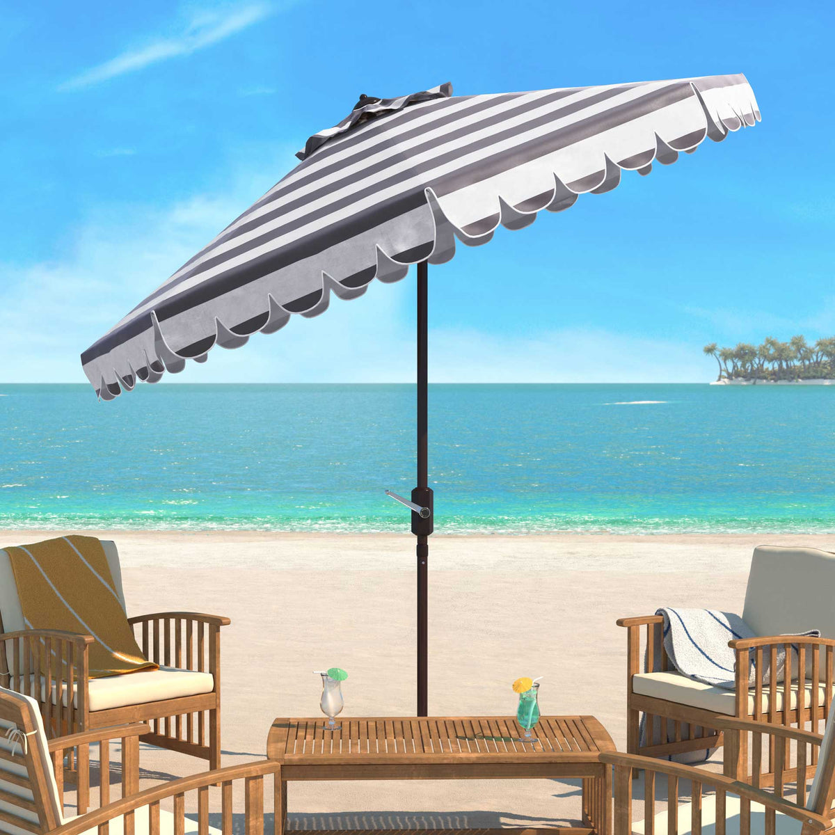 A gray and white striped umbrella shades a patio table beside the water