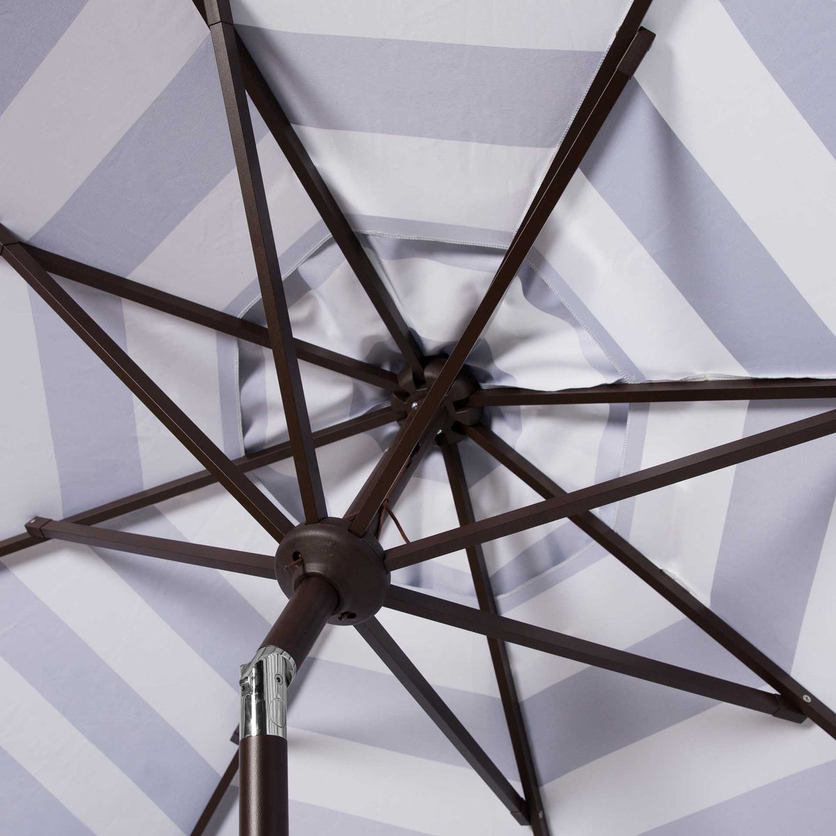 Brown metal ribs and a silver tilt joint support the navy and white striped canopy