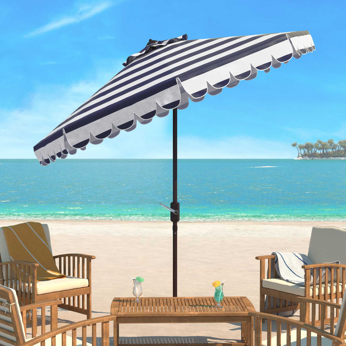 A navy and white scalloped umbrella adds shade to a seaside patio