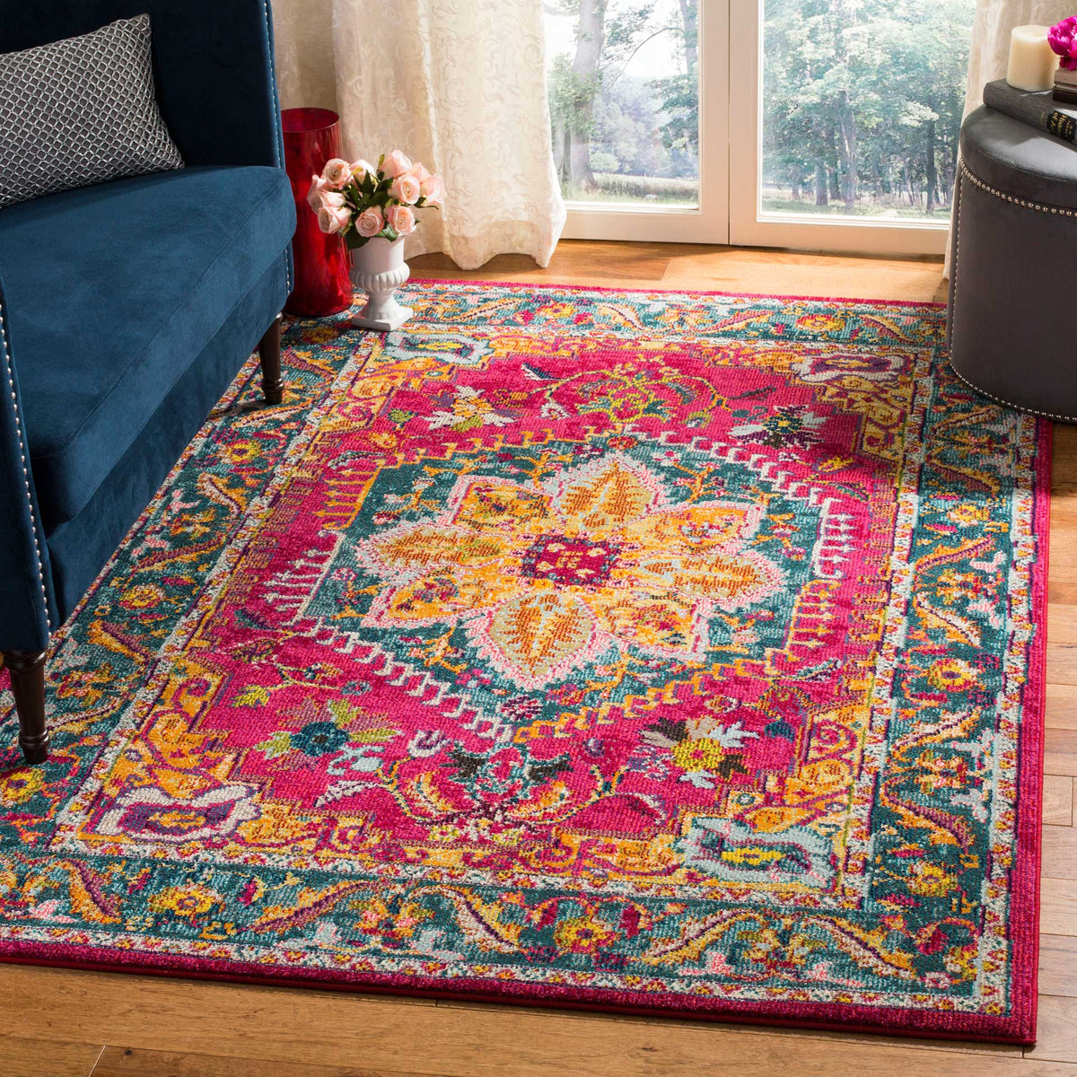 A fuchsia floral medallion and blue border brighten a cozy living space.
