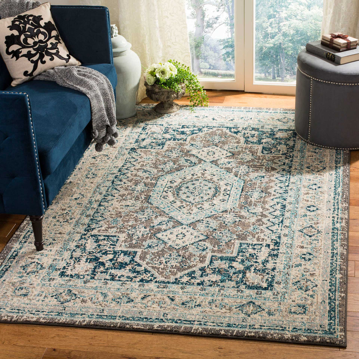An ornate blue and ivory rug brings a softly distressed pattern to a cozy living space.