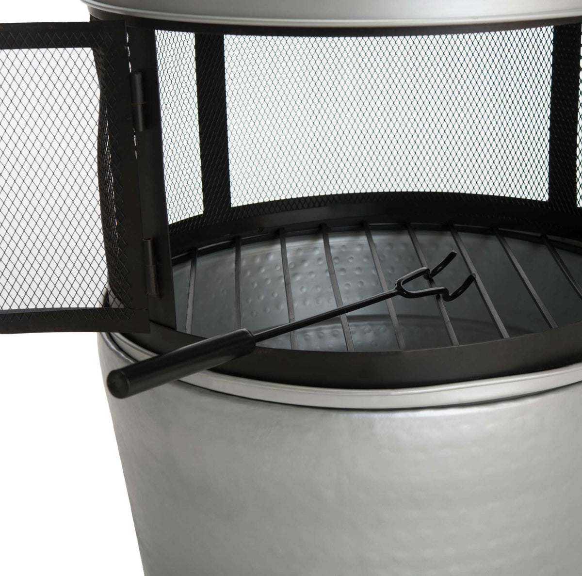 An included fire poker rests across the metal grate behind an open mesh door.
