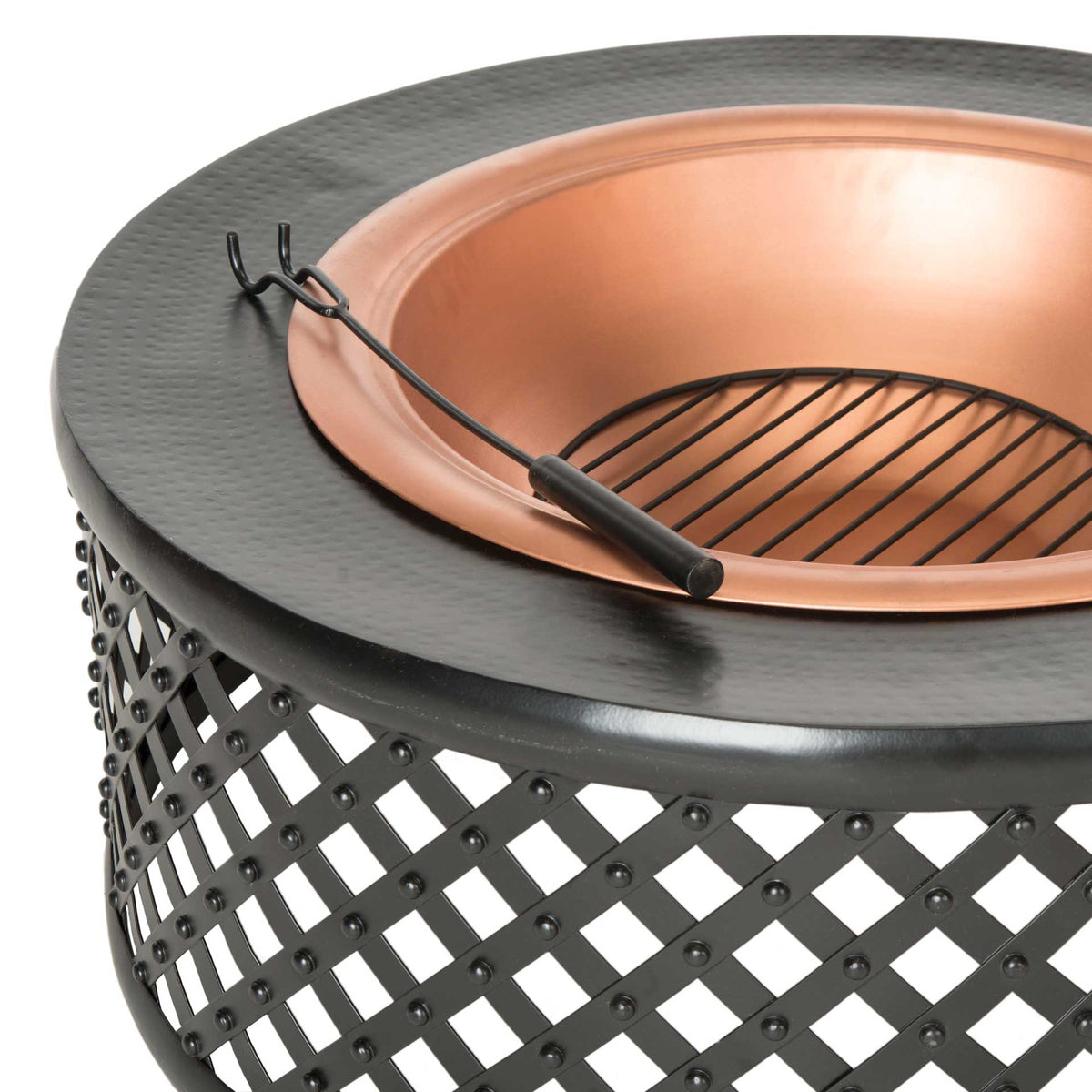 A copper-toned bowl, black grate and fire poker sit within a textured rim above riveted latticework.