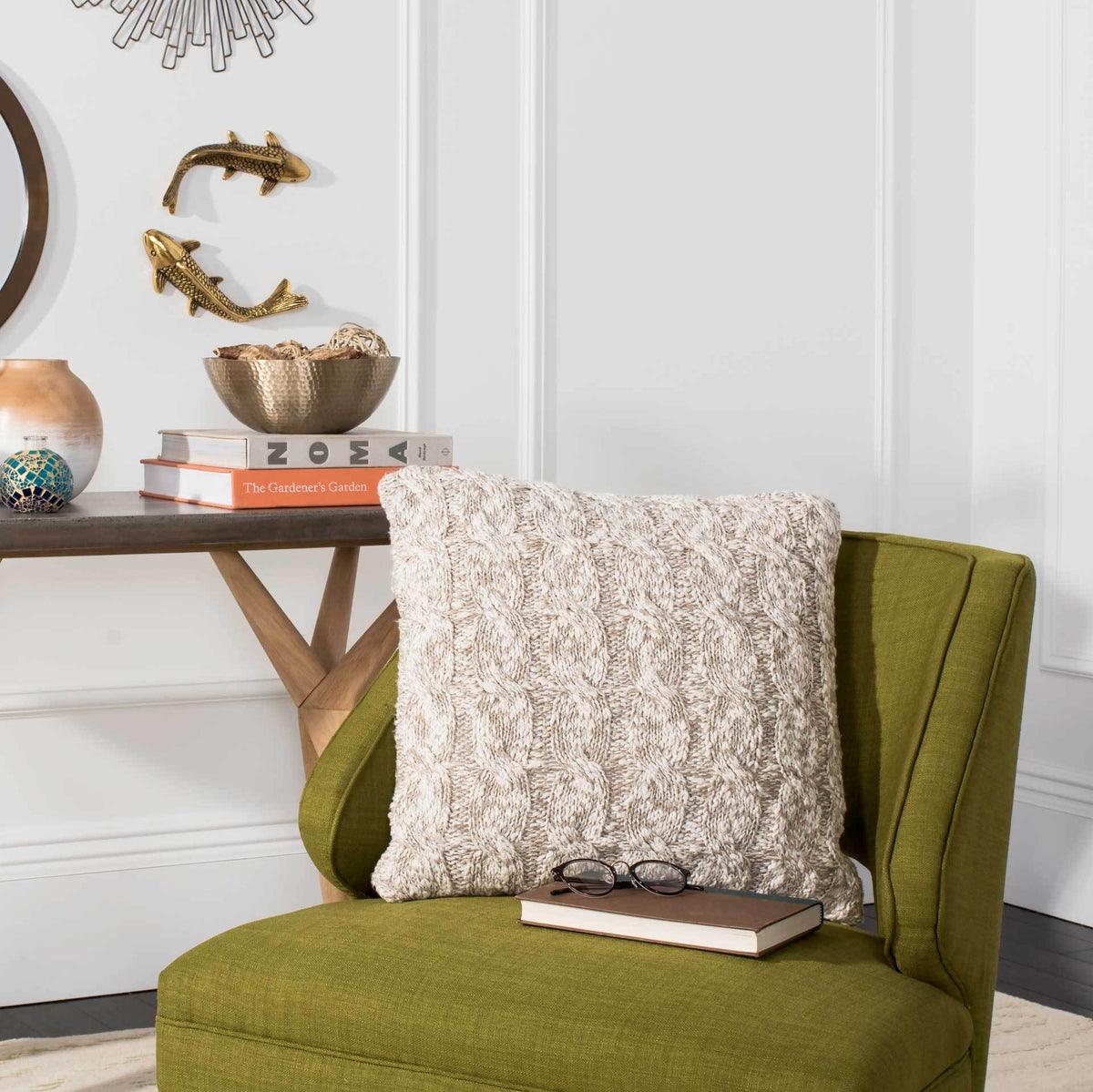 Stone and natural cable-knit pillow adds inviting texture to a green accent chair