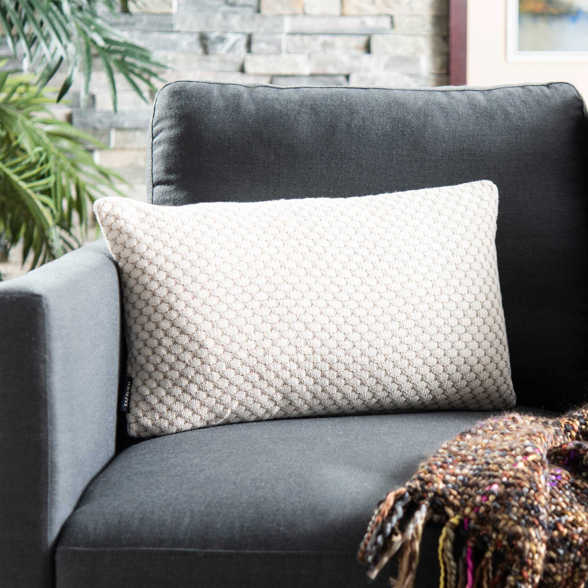 Long lumbar pillow brings cozy texture and a subtle neutral pattern to a cushioned seat