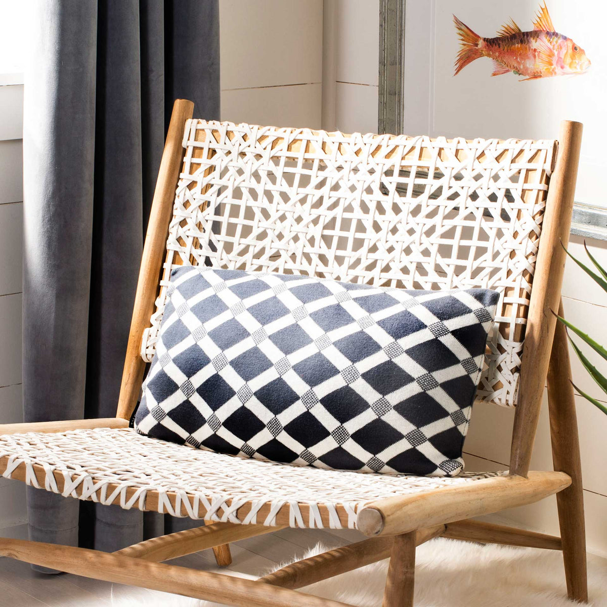 Lumbar pillow with a dark gray and natural diamond pattern and softly textured finish