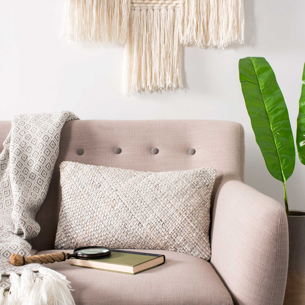 Textured white lumbar pillow adds soft contrast to an upholstered chair