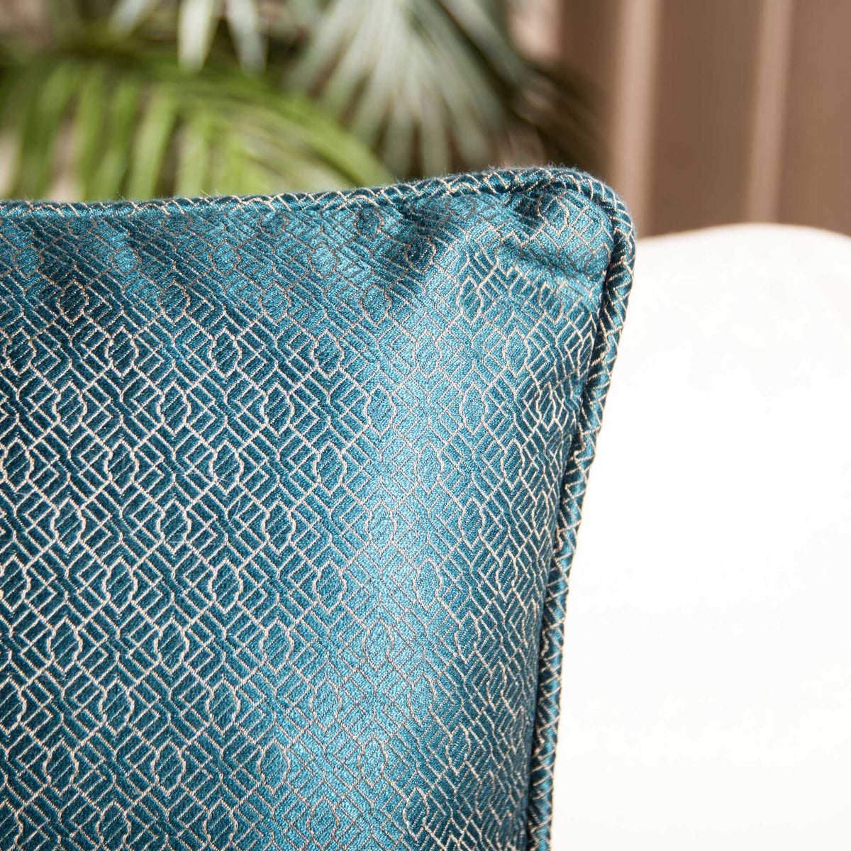 Fine beige latticework glimmers across teal fabric with a neatly finished corner