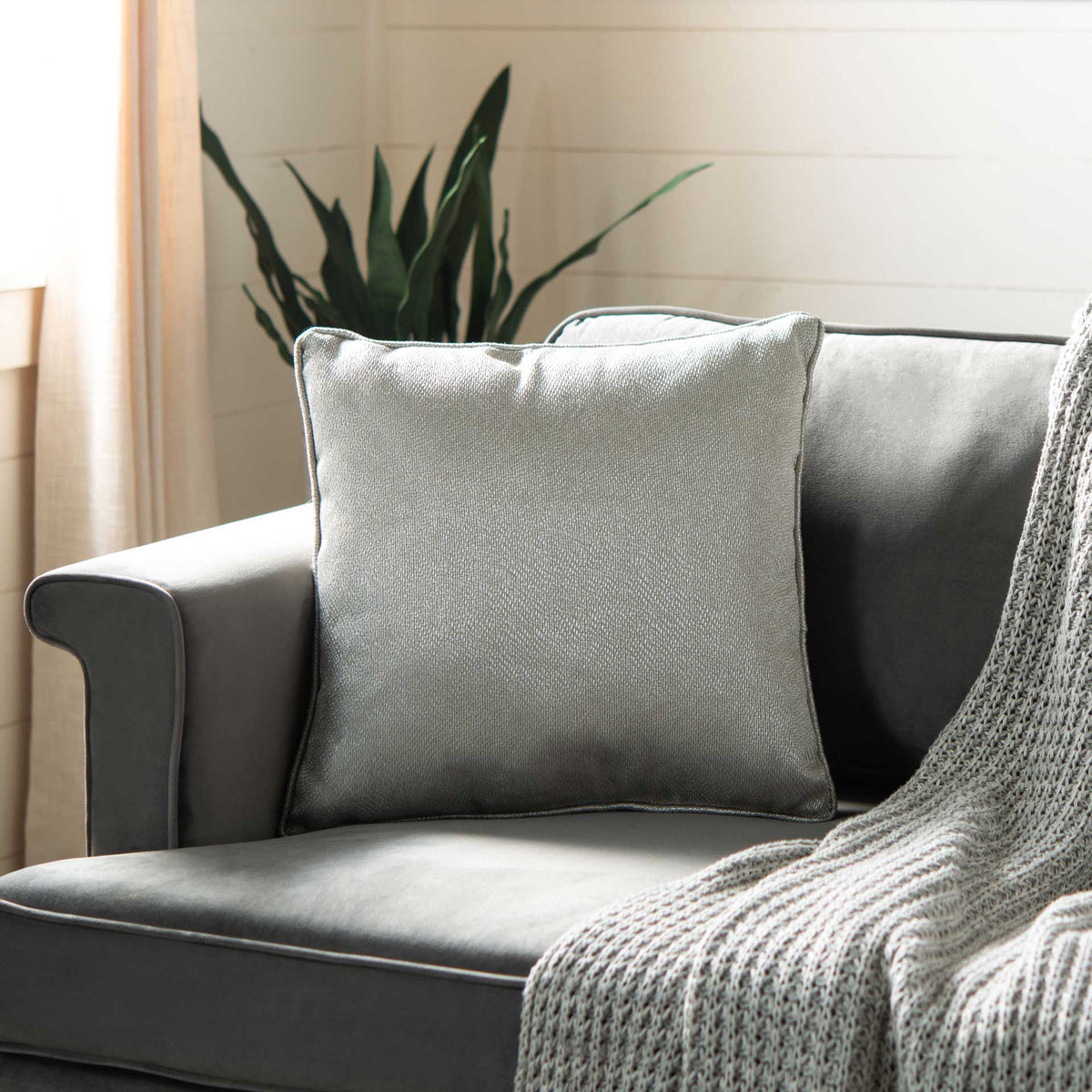 Light gray square pillow brings understated shine and cozy comfort to a sofa || PLS7079A-1818 || front_room