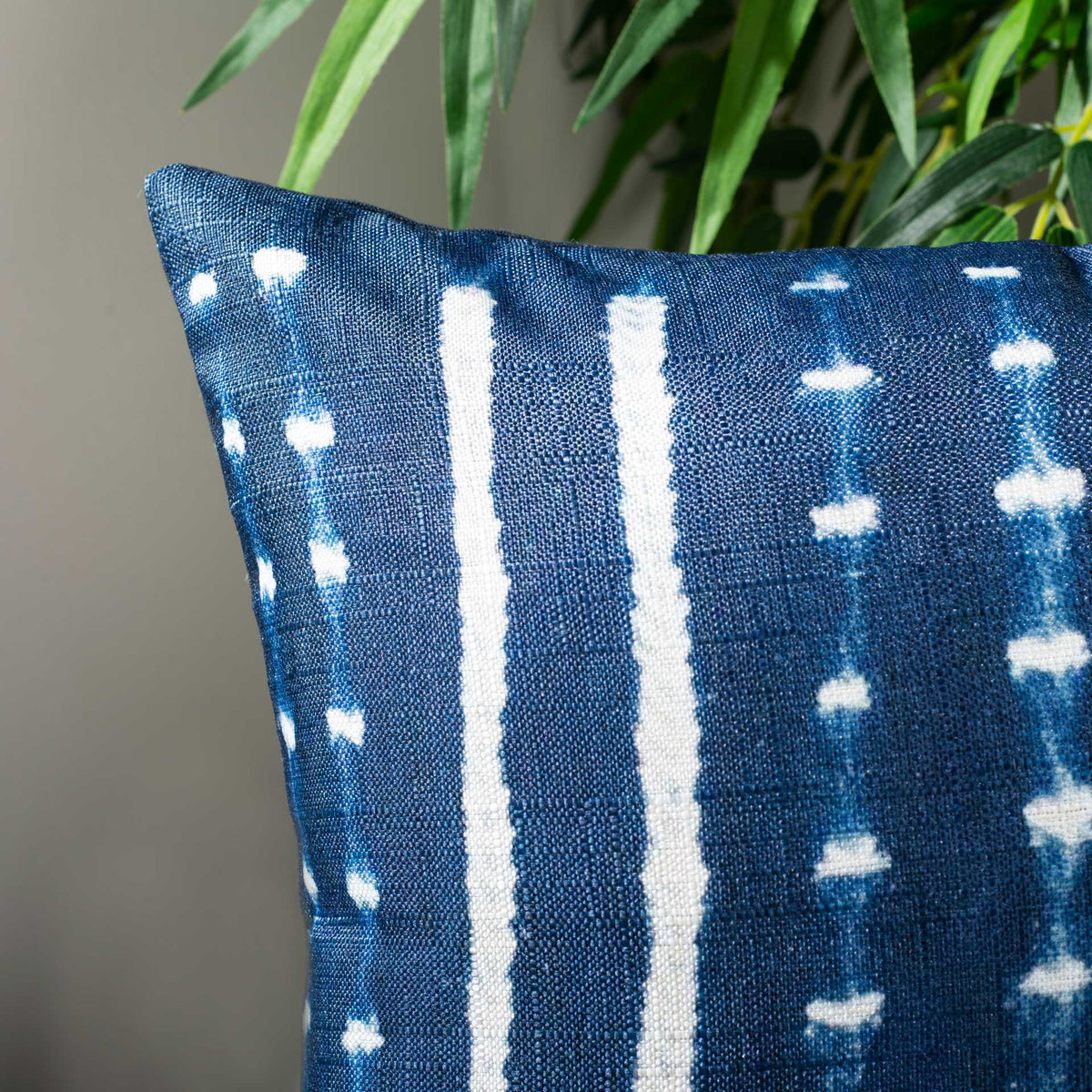 Woven blue fabric highlights broken white streaks and small dotted accents