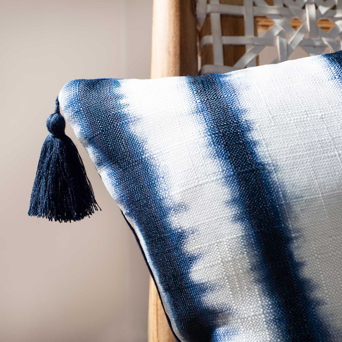 A navy tassel accents the textured fabric and softly dyed blue-and-white pattern.