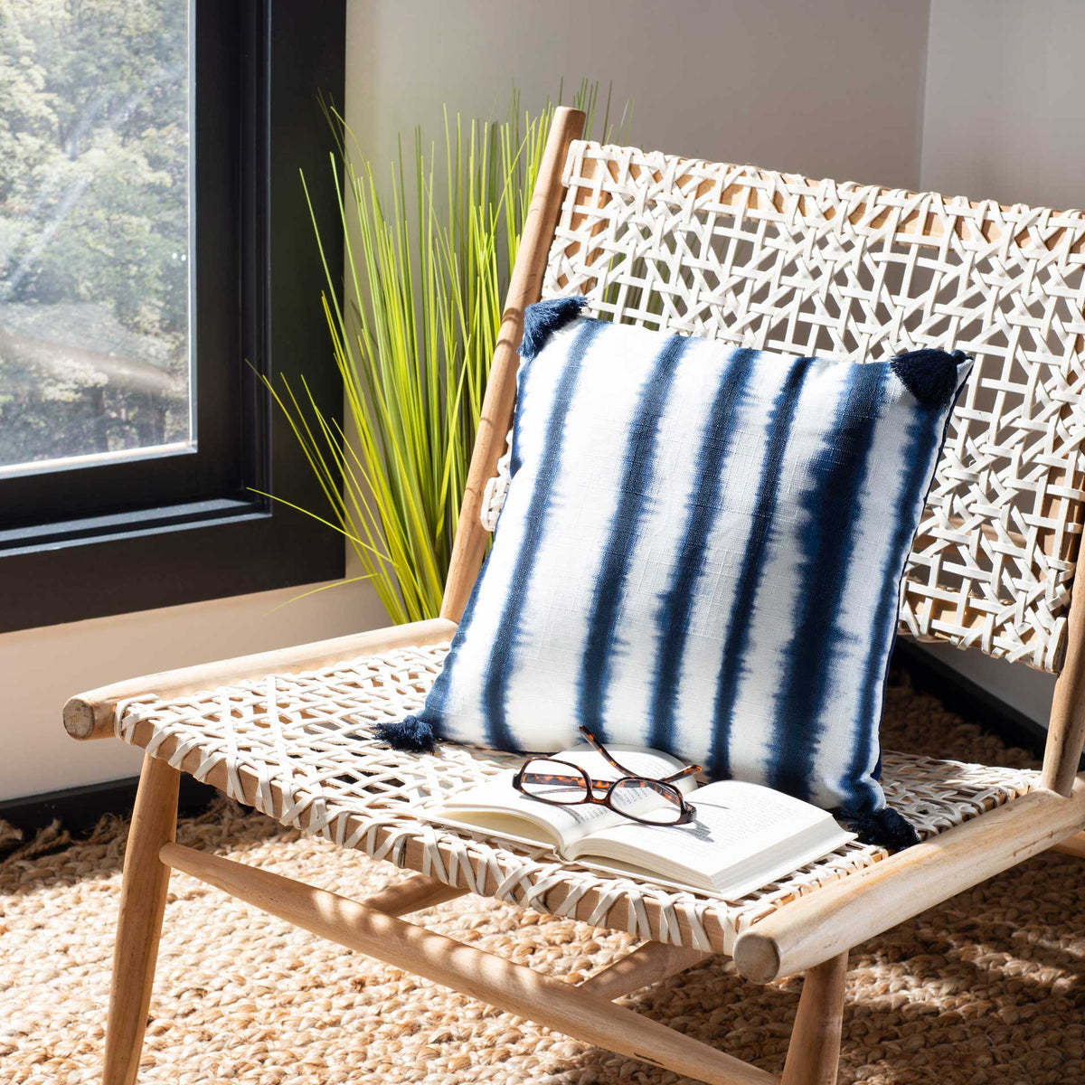 Blue-and-white stripes and playful tassels bring a relaxed accent to a woven lounge chair.