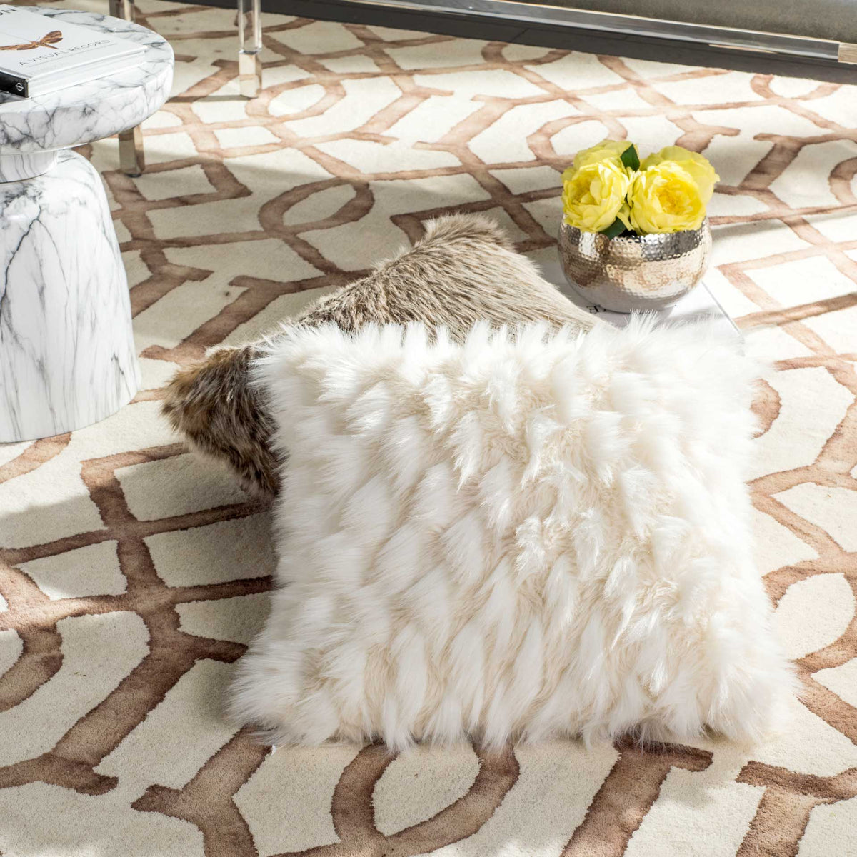 An inviting white pillow offers a featherlike finish and cozy contrast against patterned decor.