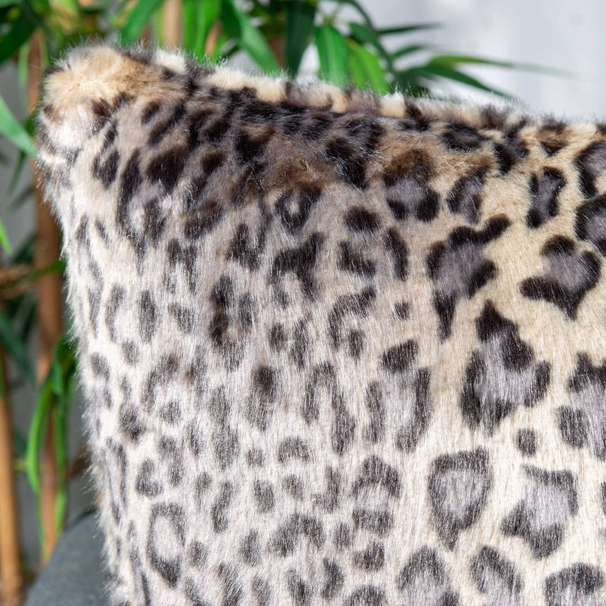 Soft leopard-patterned fur adds plush texture to this accent pillow.