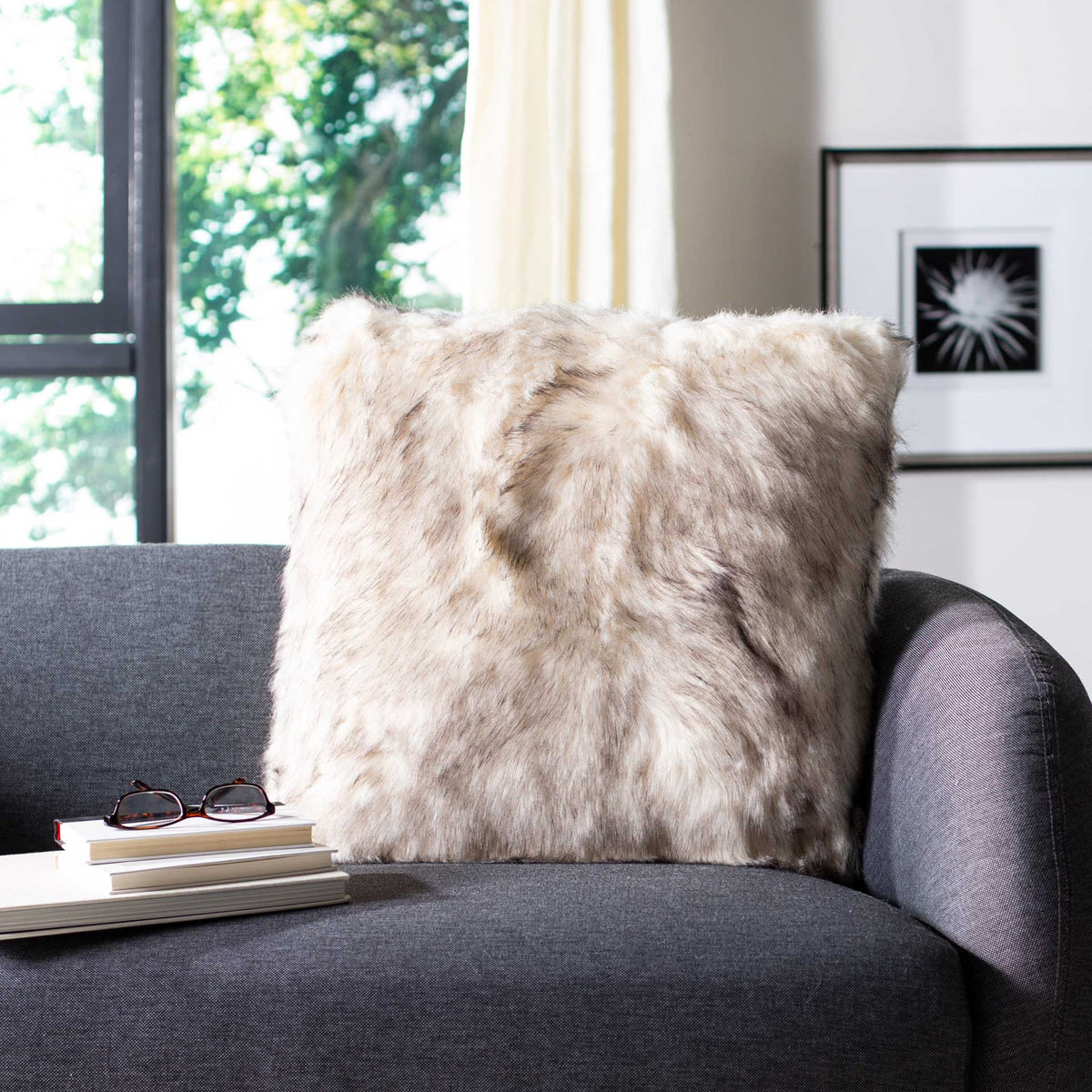 Fluffy taupe throw pillow with softly shaded fibers and a cozy texture