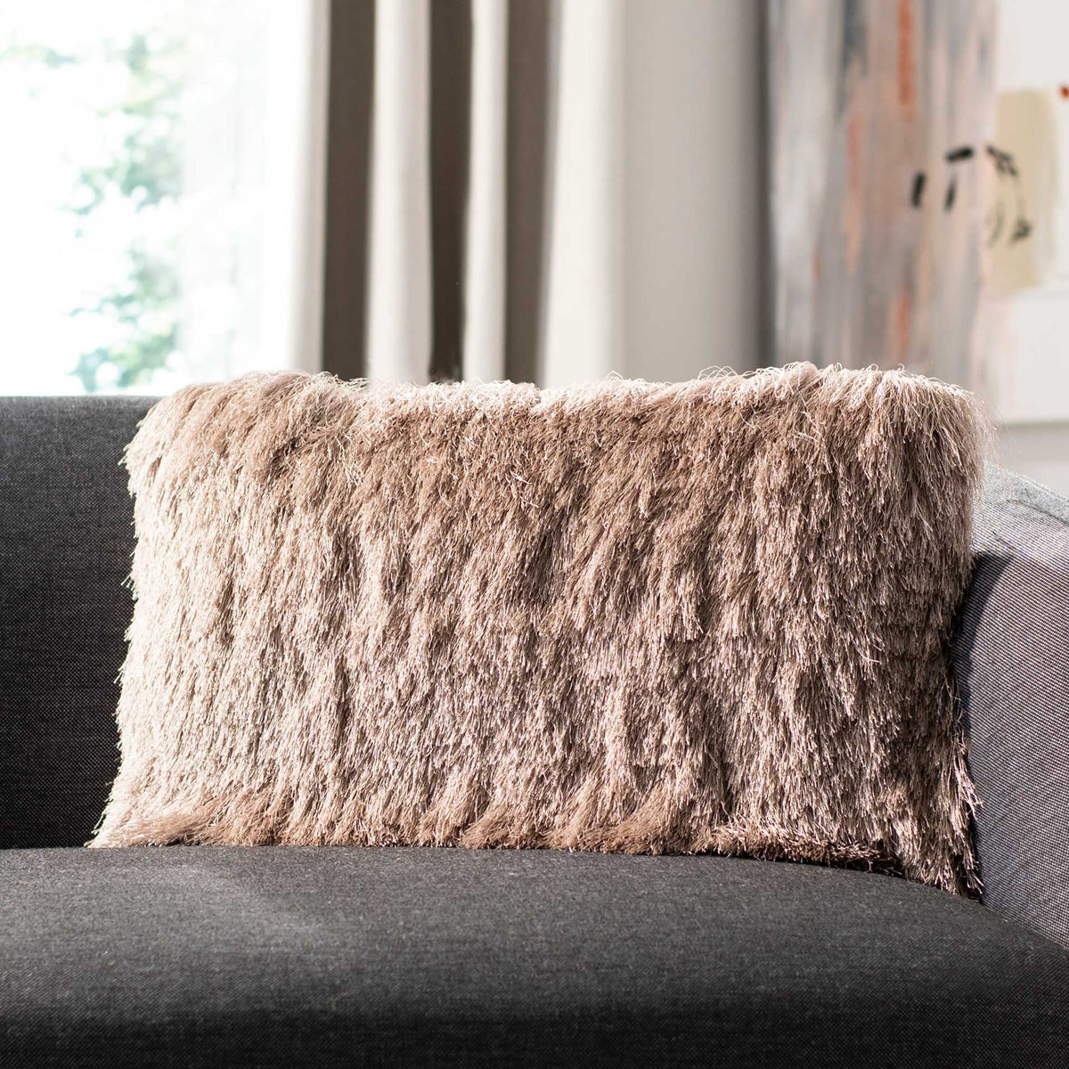 Beige shag lumbar pillow adds plush texture and cozy warmth to a sofa