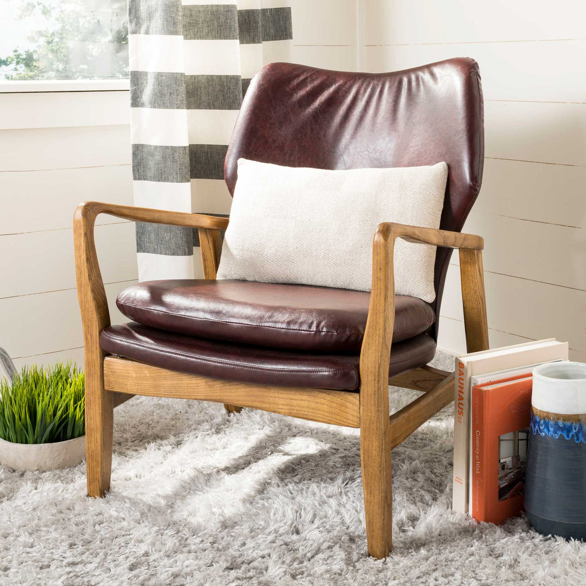 Neutral lumbar pillow adds delicate stitched texture to a leather lounge chair