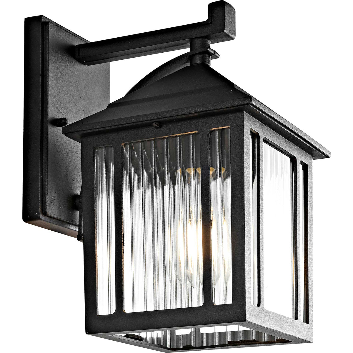 Warm light shines through ribbed glass in a black metal wall lantern with a sloped roof