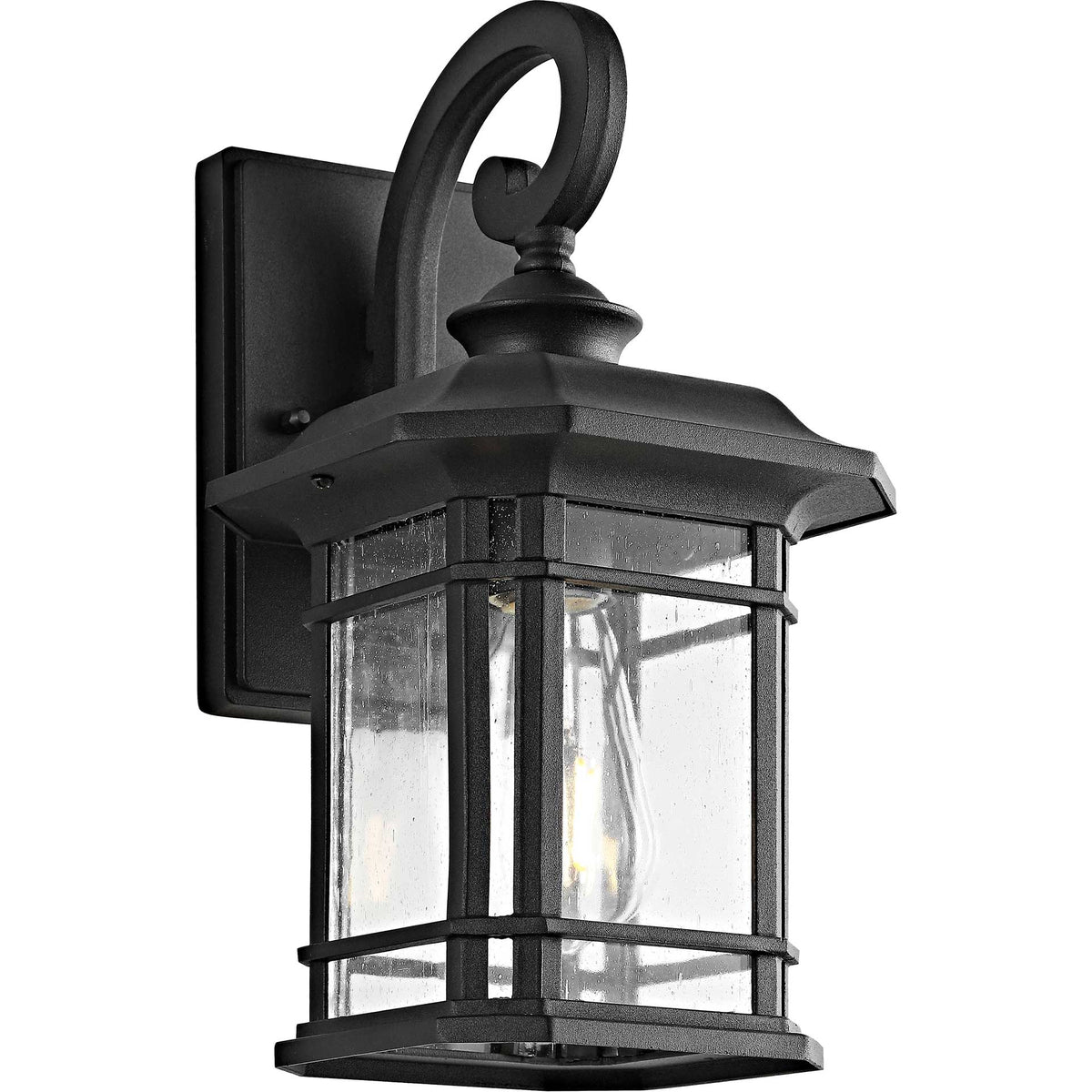 A softly glowing bulb lights the clear glass panes of a black lantern with a graceful curved arm.
