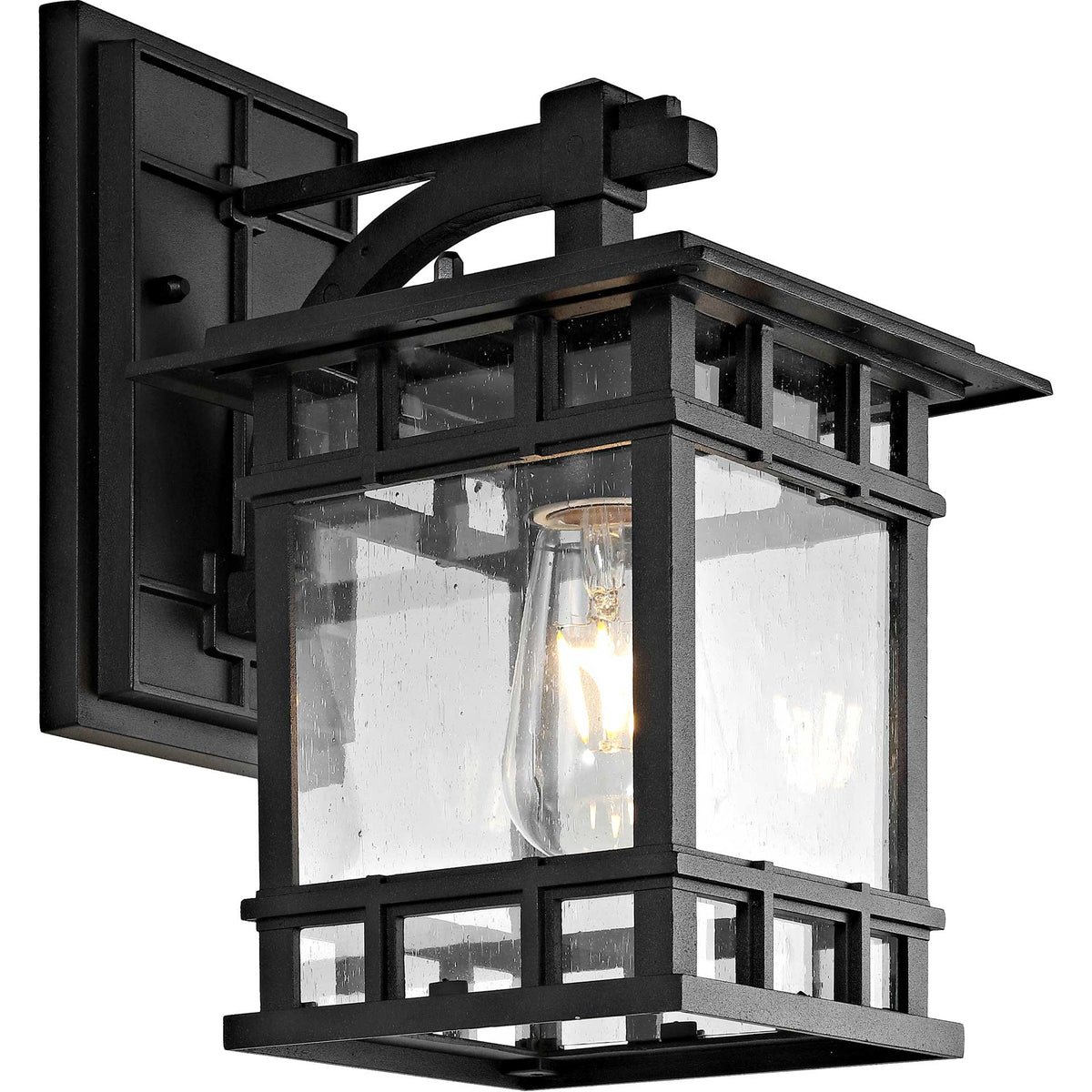 An illuminated bulb glows behind clear glass panes beneath the lantern's broad black roof