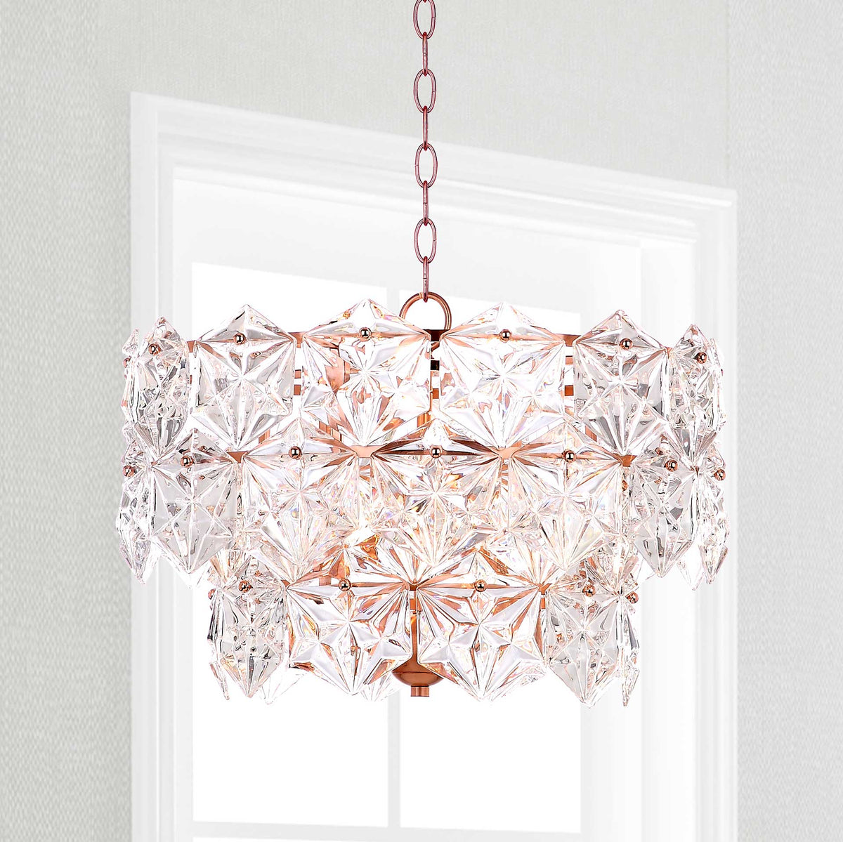 Glowing crystal panels bring warm sparkle to a tiered pendant with copper-finished detailing.
