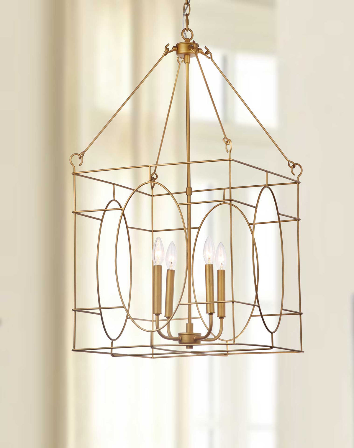 Warmly glowing bulbs highlight the pendant's delicate gold framework and curved oval details