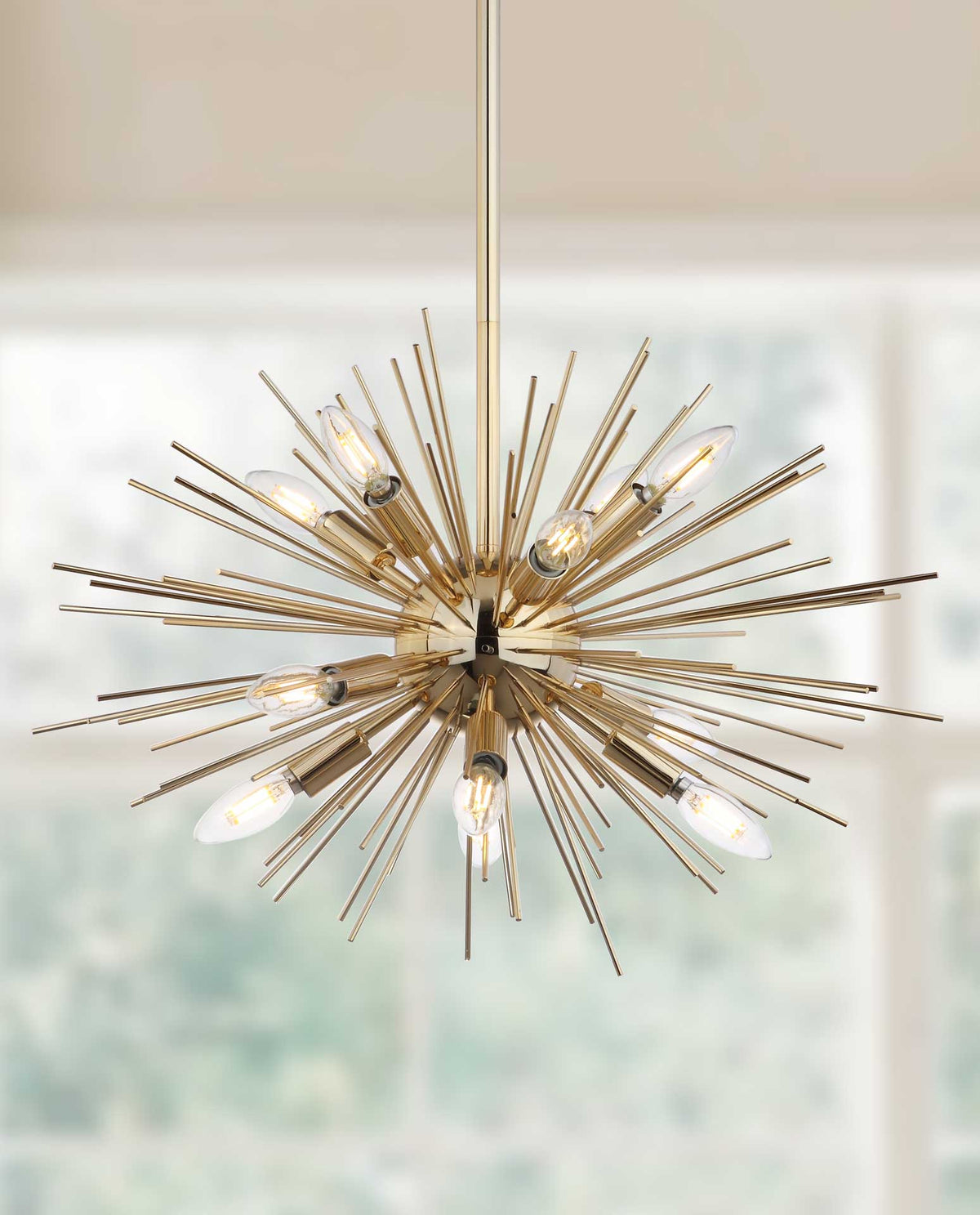 Warmly glowing bulbs shine through an airy burst of gold spokes