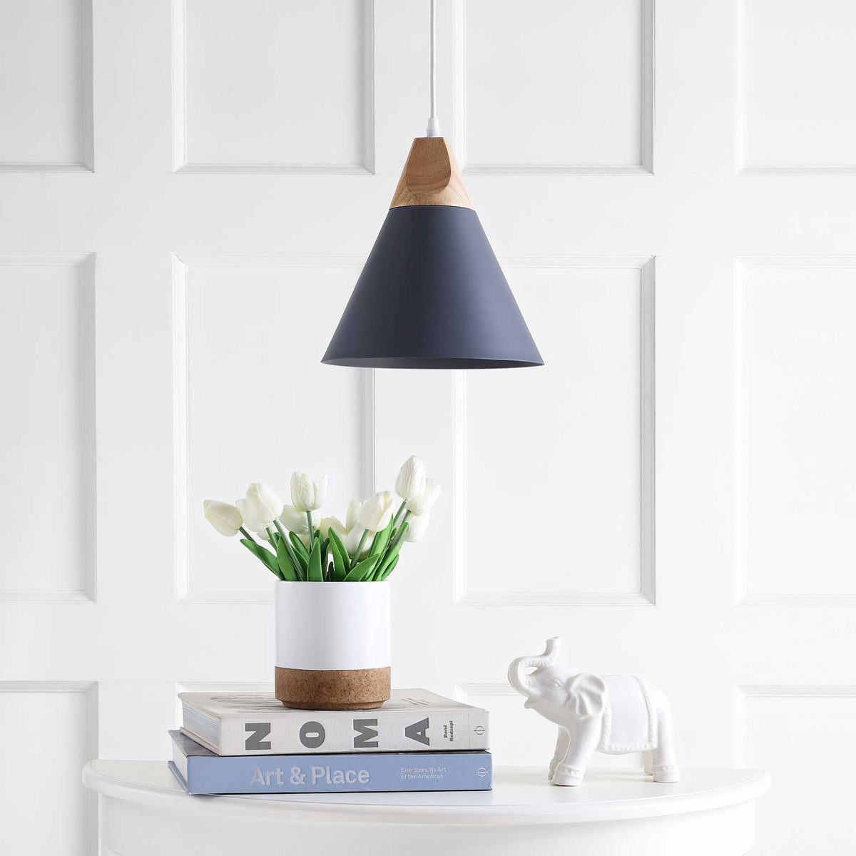 A charcoal cone shade and natural-toned collar bring clean lines above a white console.