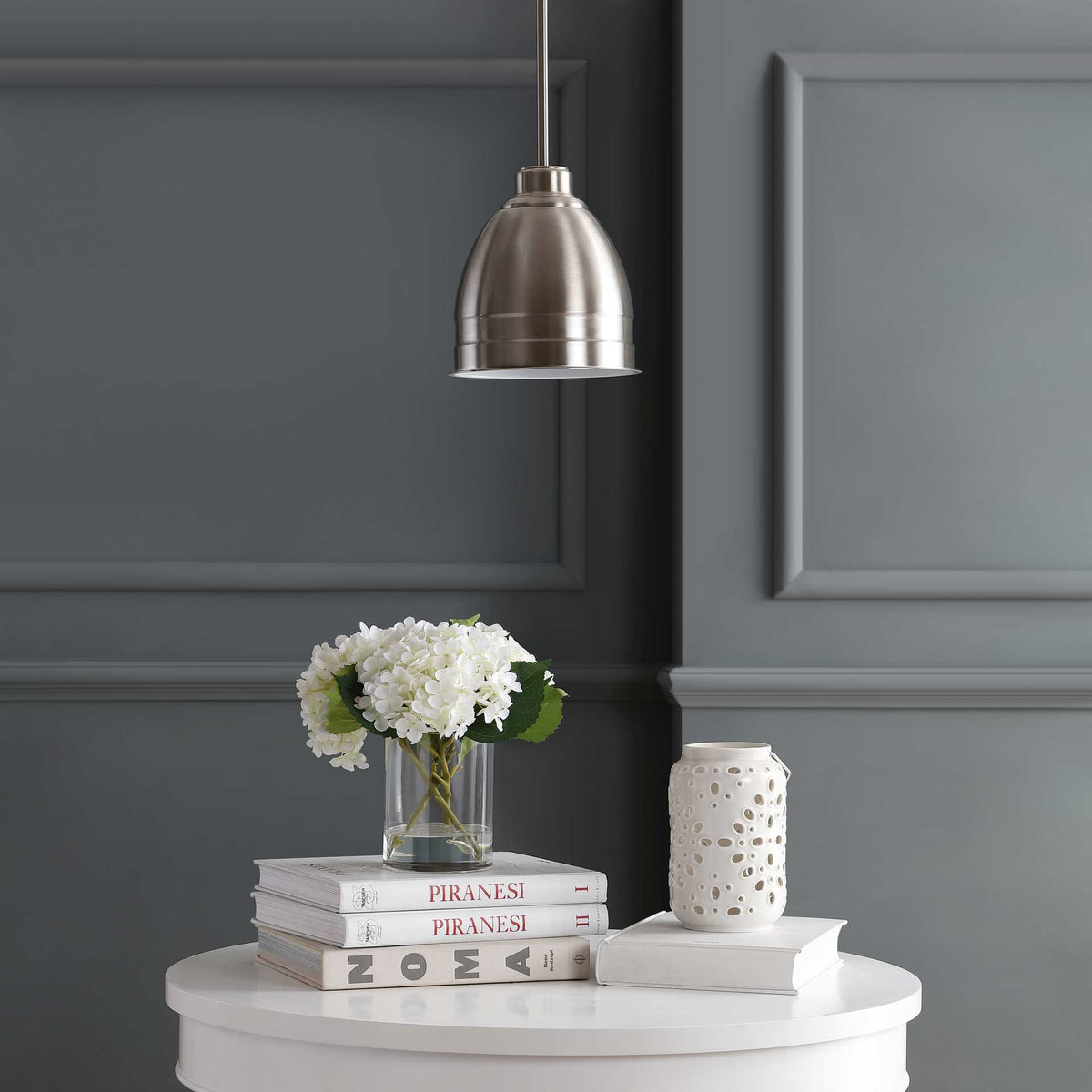 A compact nickel dome shade brings industrial character above a table