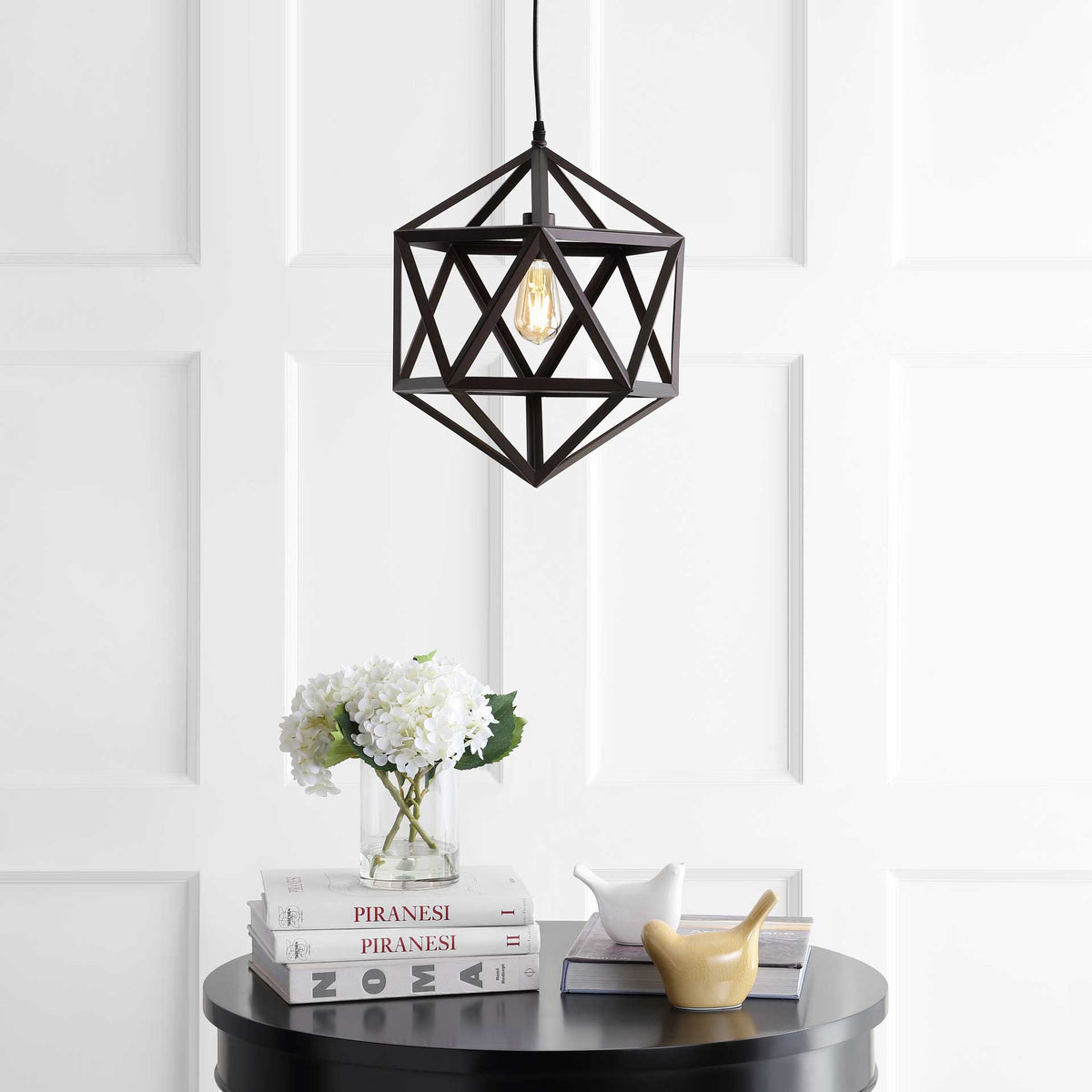 Warm light shines through an open triangular metal cage for a sculptural touch.