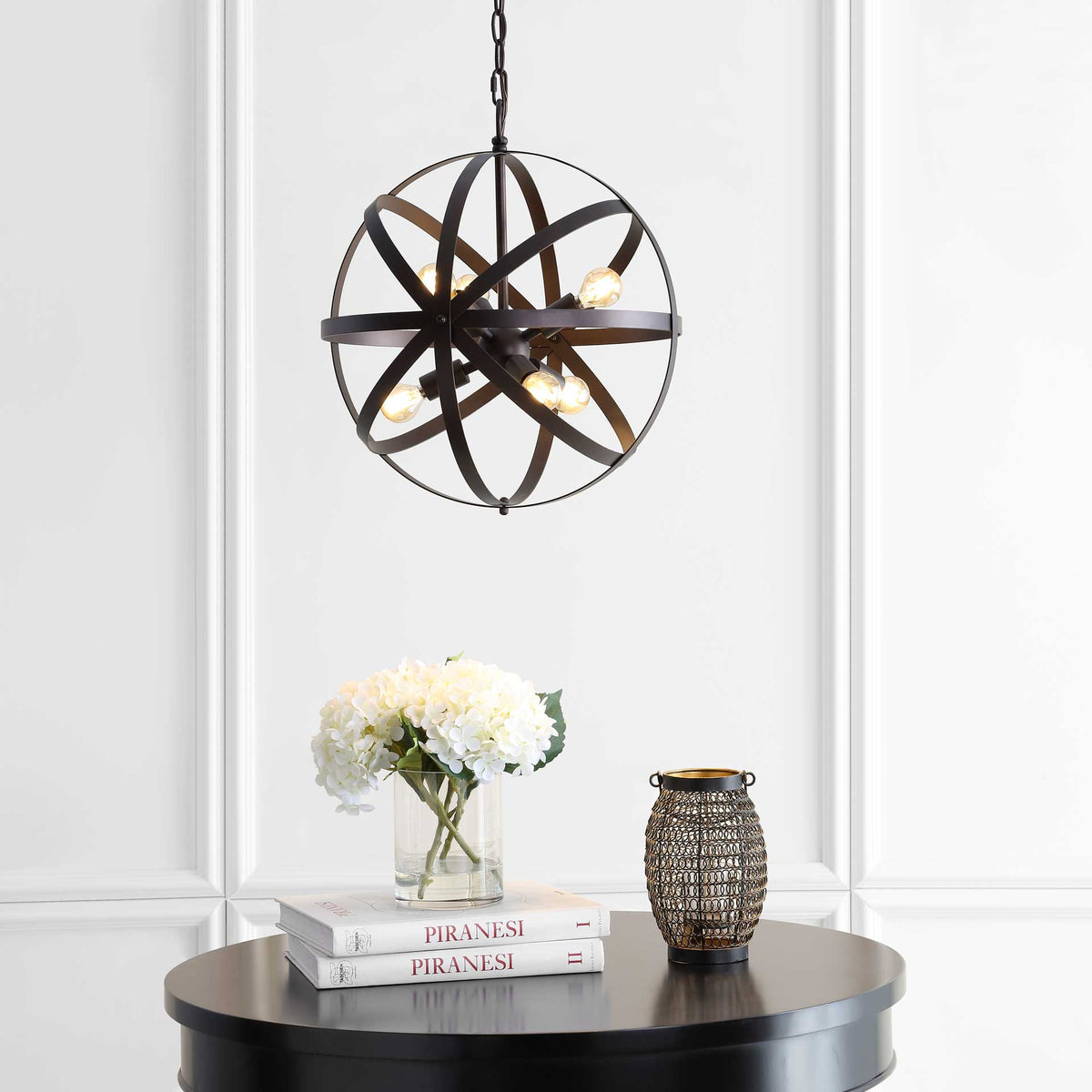 Glowing bulbs brighten the geometric pendant's dark metal frame with warm, inviting light.