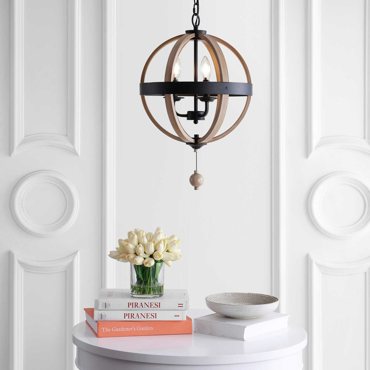 Warm light shines through curved brown ribs above a round bead finial, with black metal detailing.