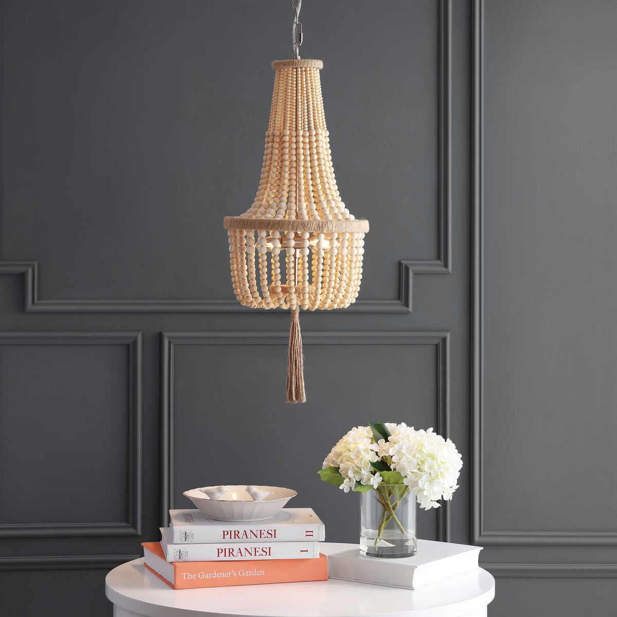 A warm glow shines through the pendant's layered wood beads and highlights its rope-wrapped rim and tassel
