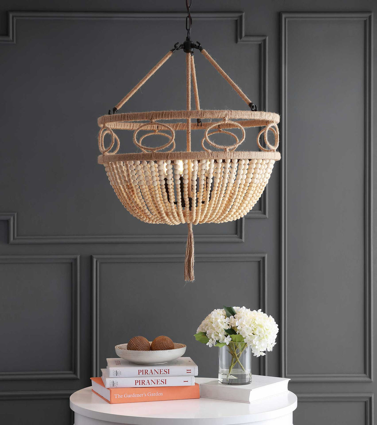 Warm light shines through cascading wood beads beneath a rope-wrapped openwork rim