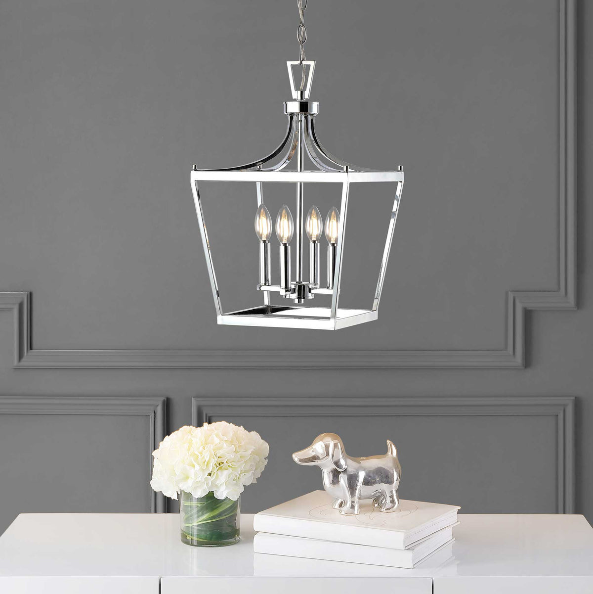 Warm light from four candle-style bulbs brightens the chrome pendant's open frame