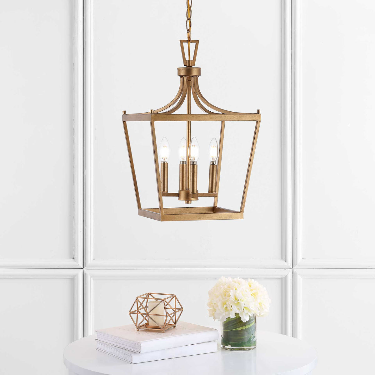 Four candle-style lights lend a warm glow to the gold pendant's tapered open frame