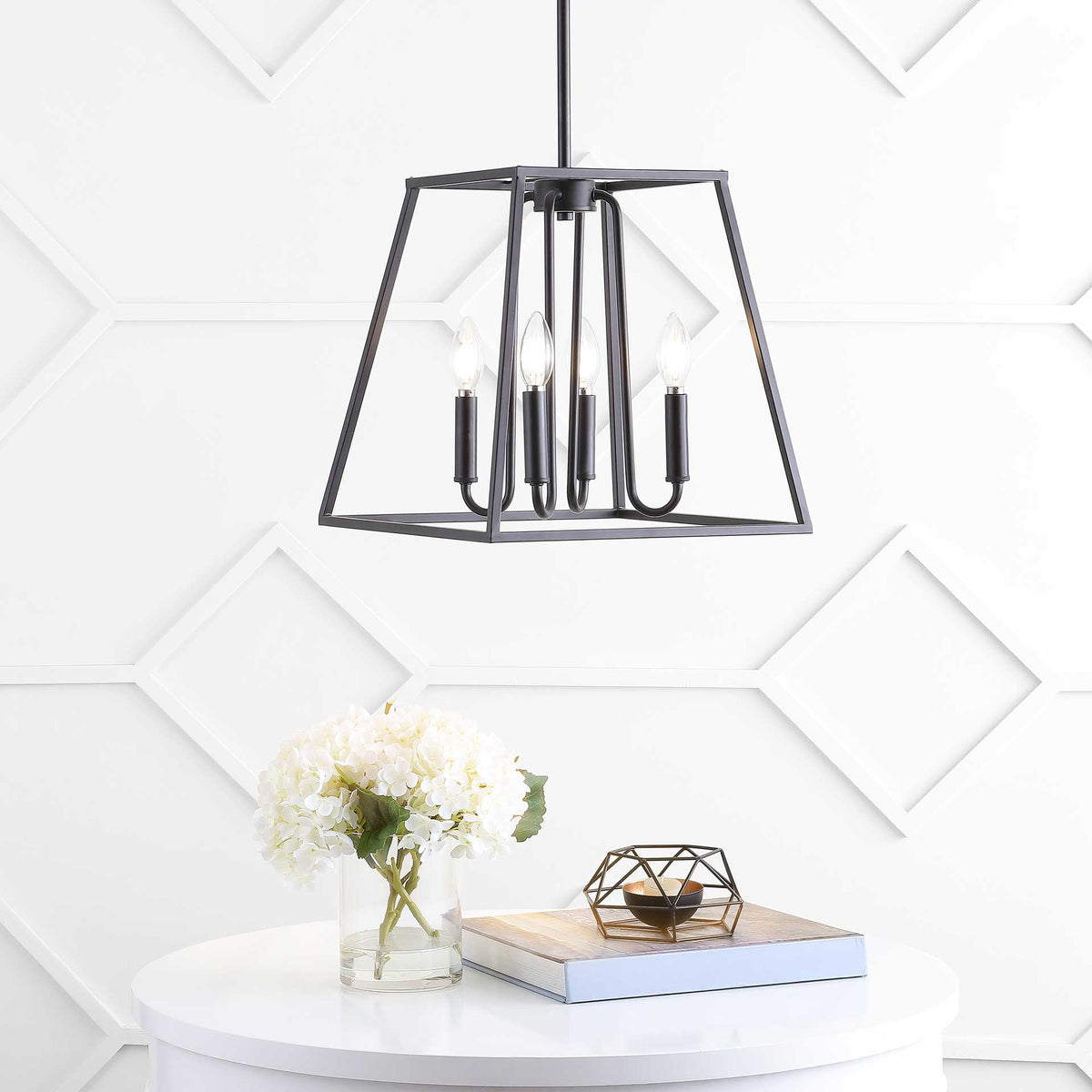 Glowing candle-style bulbs warm the bronze pendant above a white table