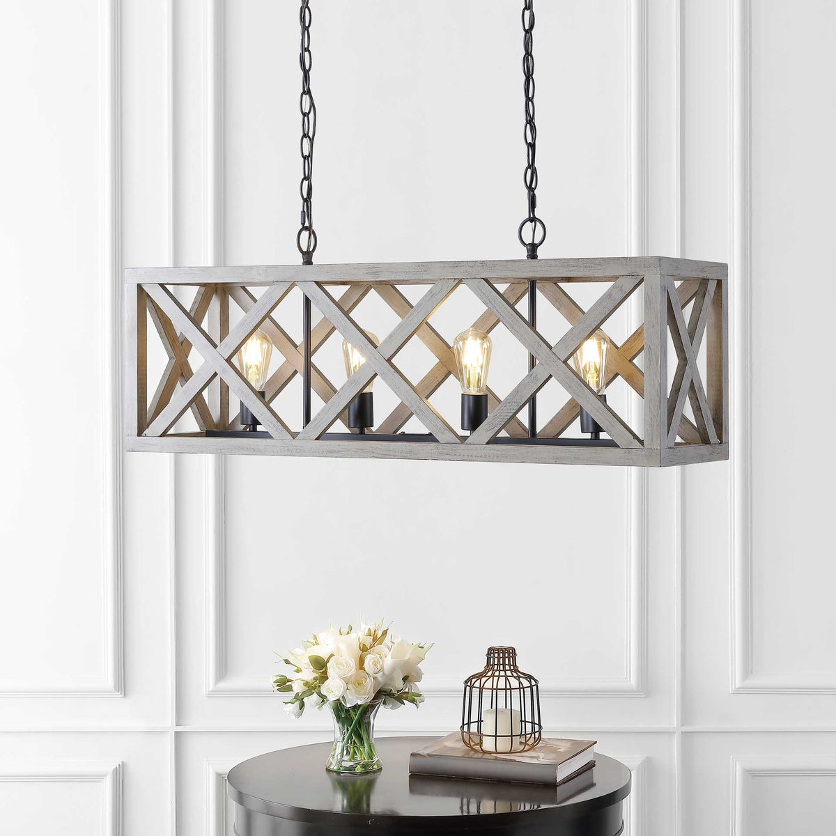 Four glowing bulbs shine through the crisscross wood frame above a round table