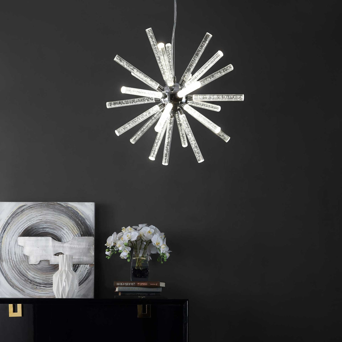 Illuminated starburst pendant brightens the space above a modern console