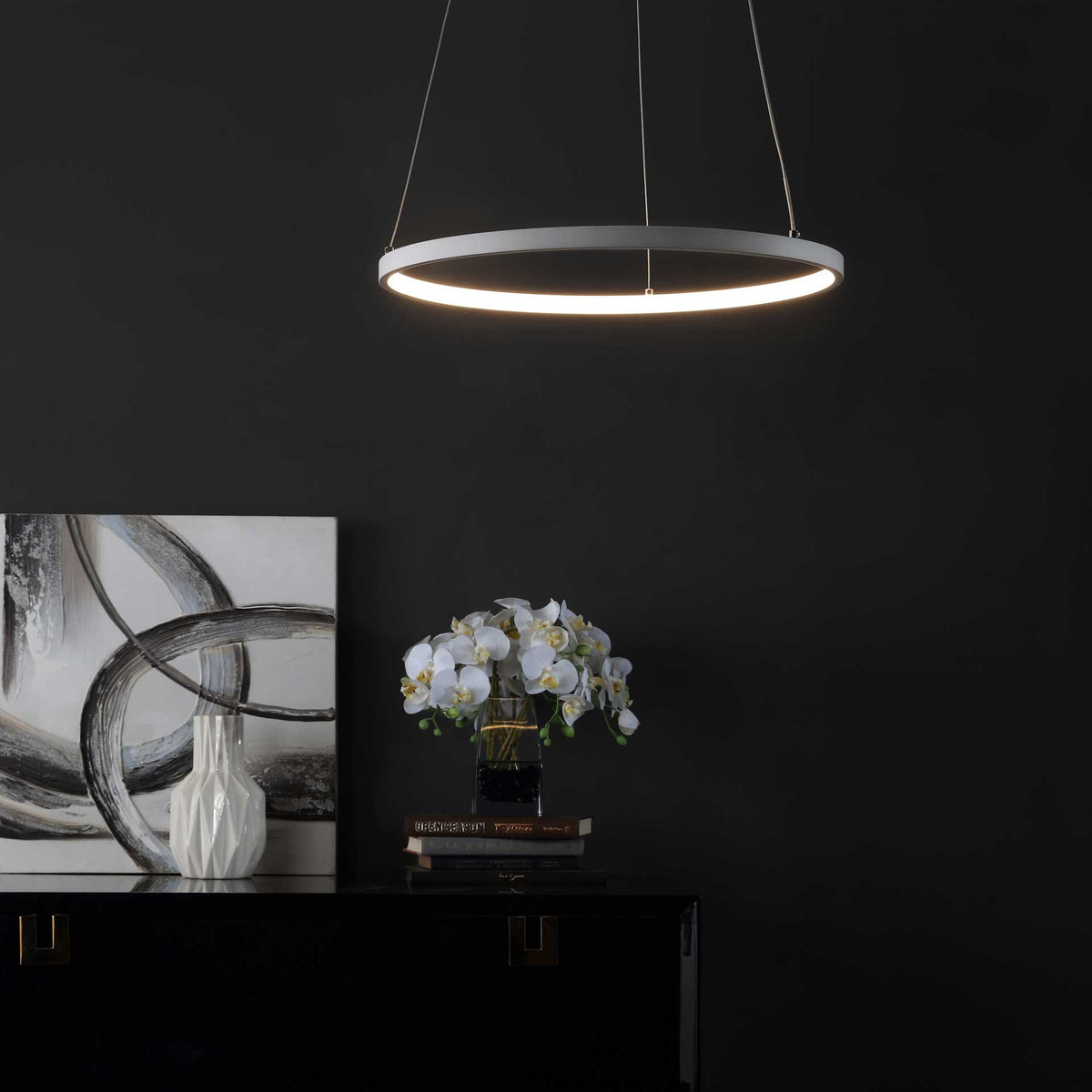 Warm LED light outlines a sleek white ring, creating an inviting glow over a modern cabinet.