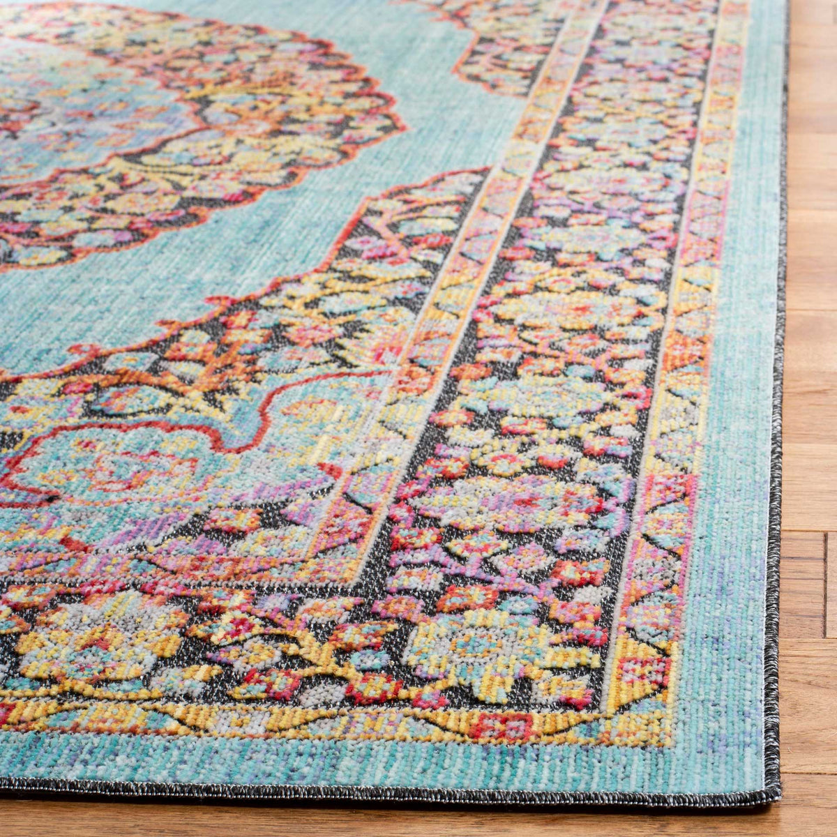 Aqua edging frames the rug's richly colored floral border